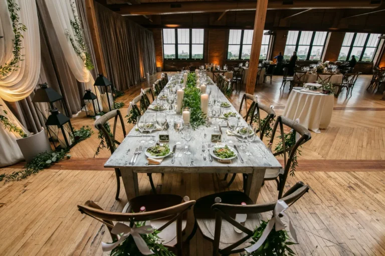 Reception table with candles and greenery at a wedding — 10K budget wedding ideas