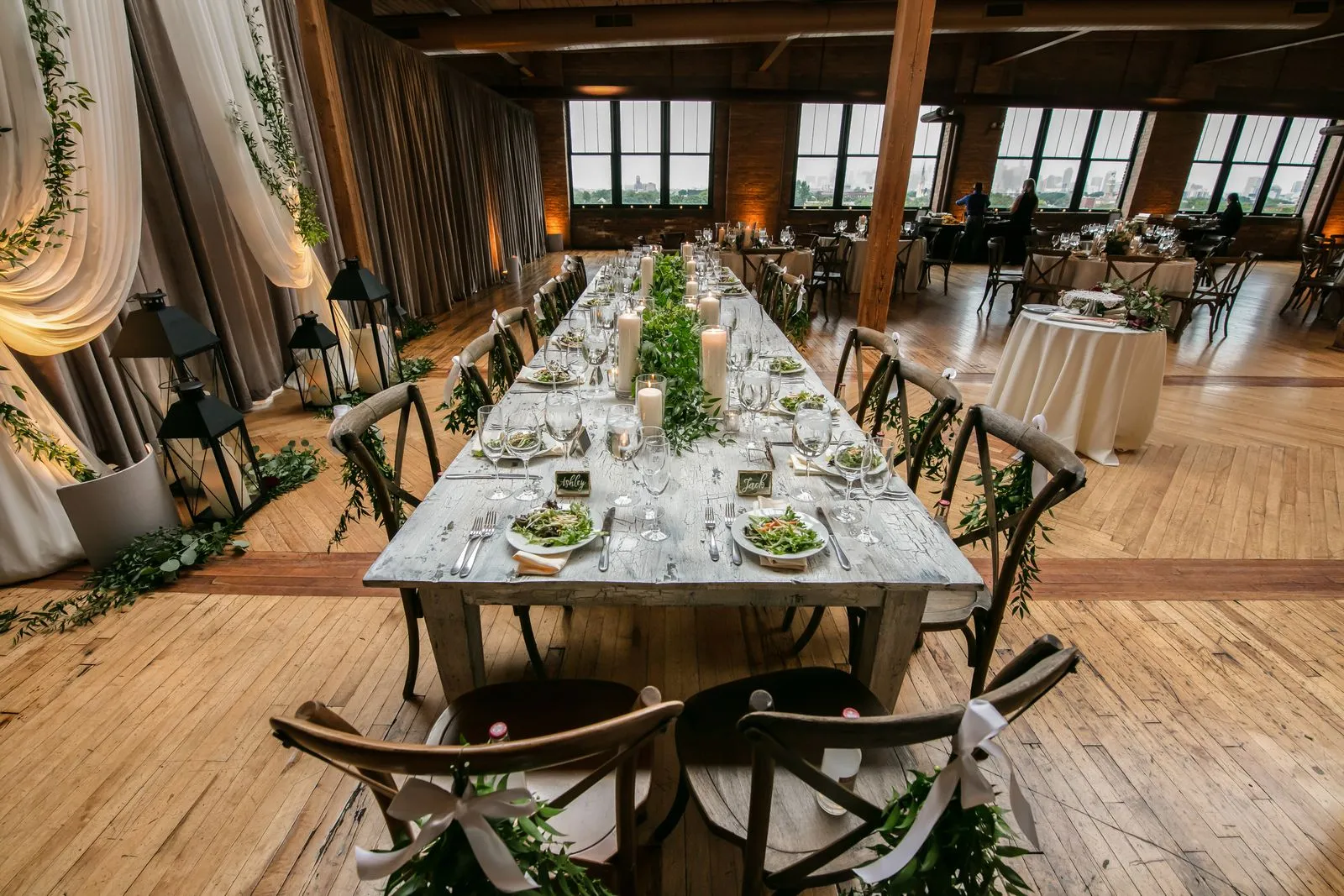 Reception table with candles and greenery at a wedding — 10K budget wedding ideas
