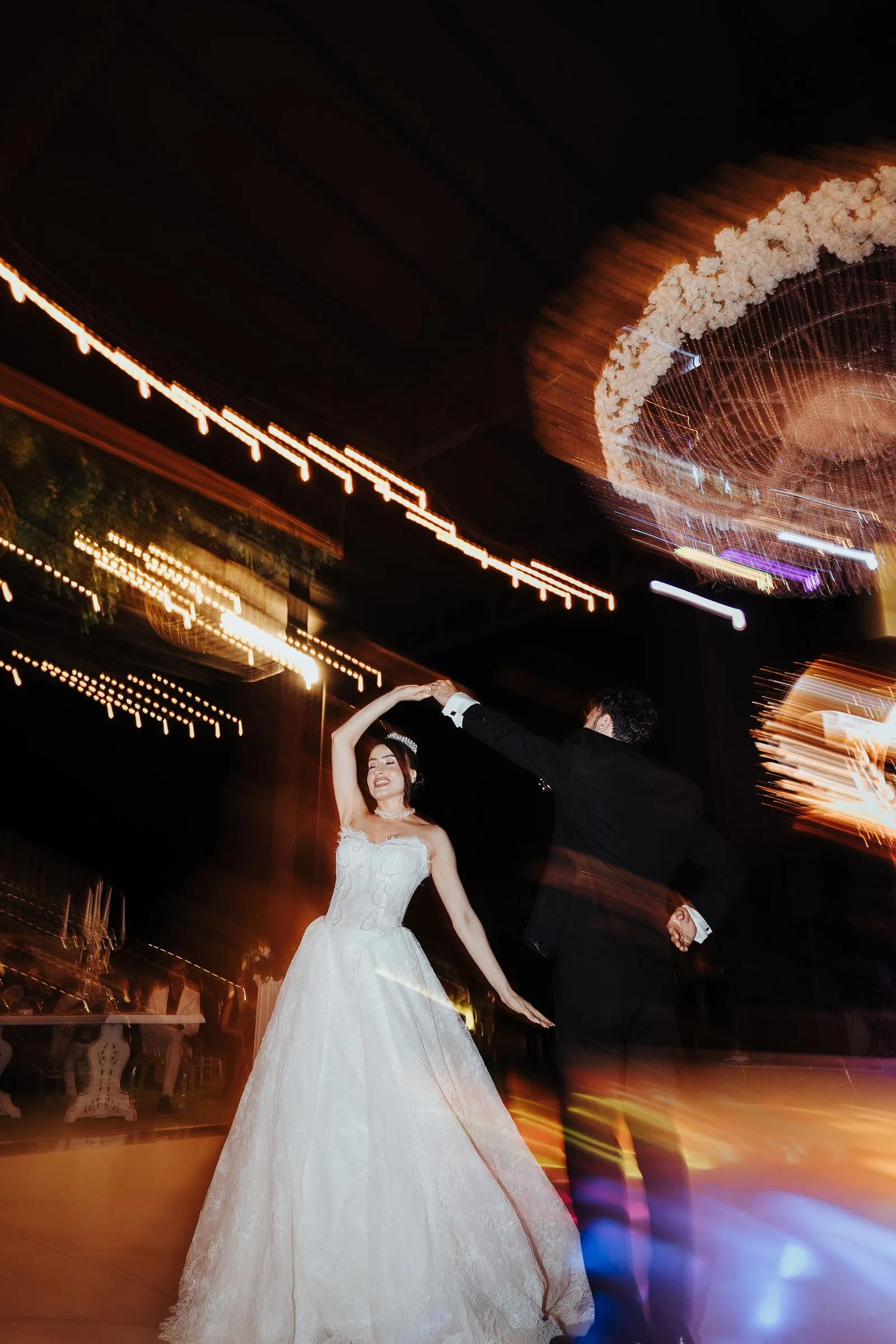 Couple dancing under twinkling lights at a wedding reception — 10K budget wedding ideas
