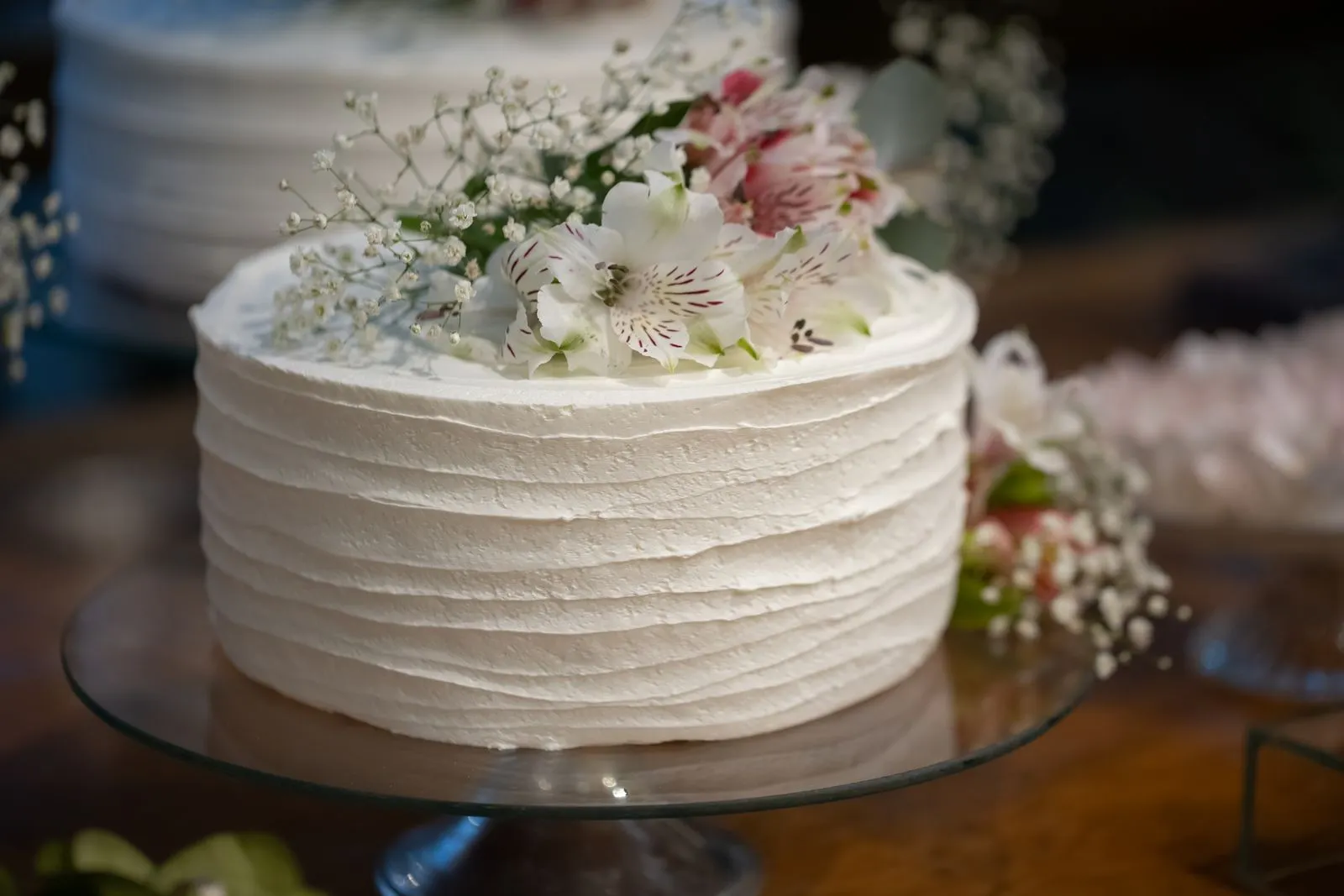 Elegant white wedding cake with floral decoration — 10K budget wedding ideas