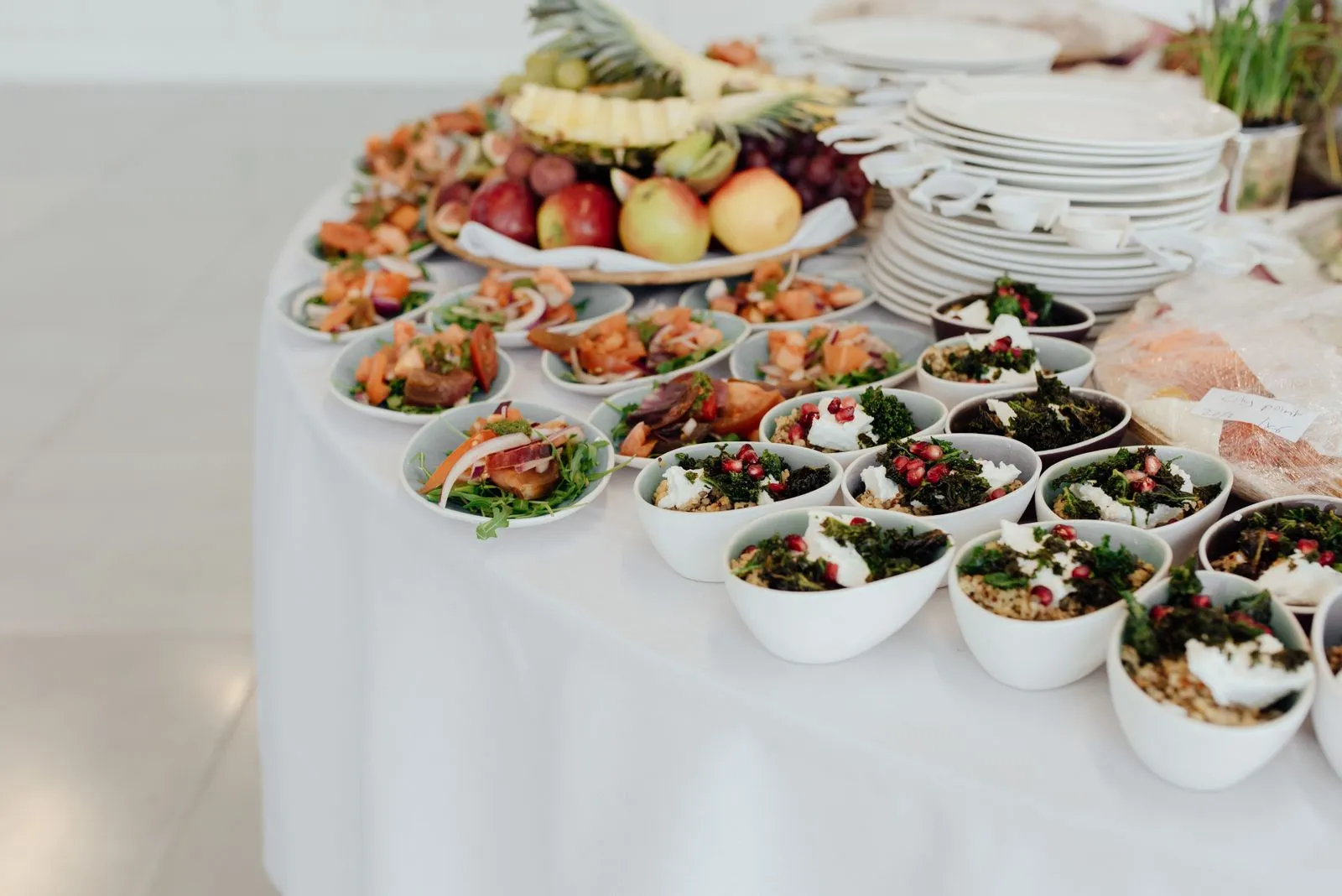 A beautifully arranged buffet table with dishes, fruits and salads for a wedding reception