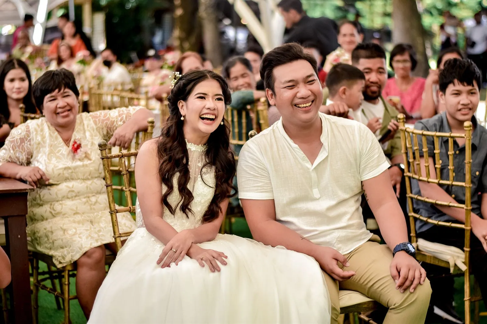 A laughing couple at their outdoor wedding
